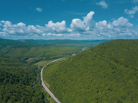 Aerial view of a rural highway between mountains