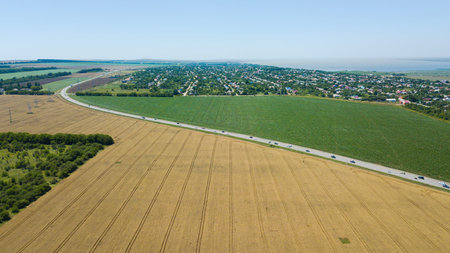 Aerial view of a country road in beautiful agricultural fields in Russia