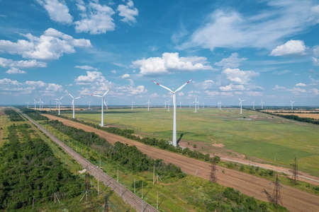 Aerial view of Wind power turbine is a popular sustainable, renewable energy source on beautiful cloudy sky. Wind power turbines generating clean renewable energy for sustainable development.の写真素材