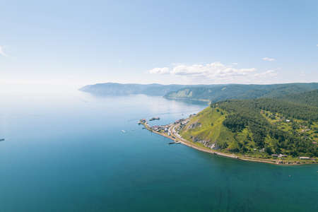 Lake Baikal is a marvelous blue jewel framed by scenic mountains and forests. Epic cinematic aerial view Lake Baikal. Aerial view of blue lake and green forests.の写真素材