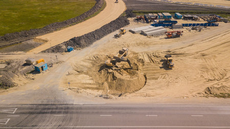 Excavator Is Loading Ground Into Truck On Construction Of Traffic Interchange