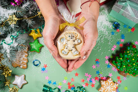 New years chocolate tiger in hand. Chocolate tiger, symbol of the year 2022. Joyful mood.の写真素材