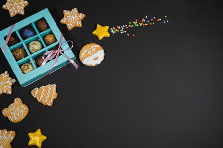 Christmas background with gingerbread on gray surface. Holiday mood card. Top view, copy space. Family traditions, DIY, celebration concept. Festive background with homemade gingerbread cookies.の写真素材