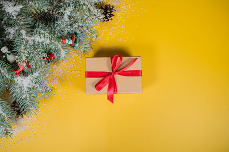 Christmas holidays composition on yellow background with gift and copy space for your textの写真素材