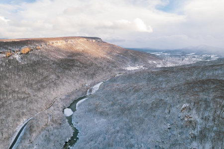 Aerial view of Plateau Lago-Naki mountain twisted road in the winter and driving car. Epic, snowy...