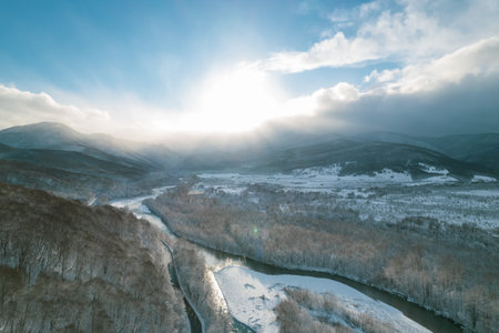 Aerial view of Plateau Lago-Naki mountain twisted road in the winter and driving car. Epic, snowy...