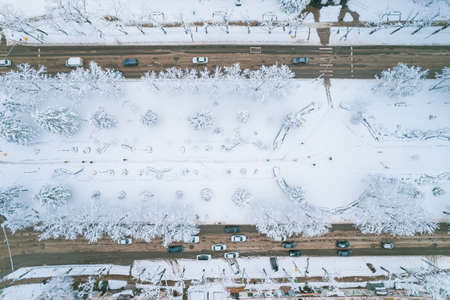 Aerial top down view of snowy city asphalt road, landscapes in winter.の写真素材
