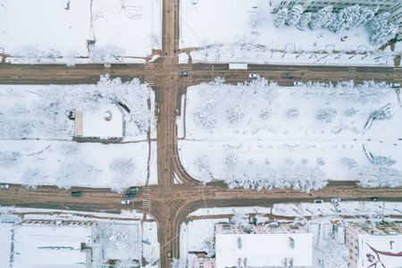 Aerial top down view of snowy city asphalt road, landscapes in winter.の写真素材