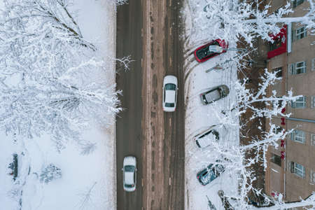 Aerial top down view of snowy city asphalt road, landscapes in winter.の写真素材