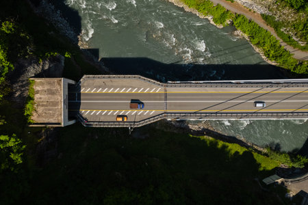 Cable-Stayed Bridge on the Adler-Krasnaya Polyana motorway. Aerial view of car driving along the winding mountain road in Sochi, Russia.の写真素材