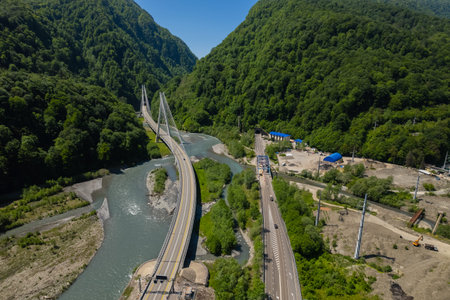 Cable-Stayed Bridge on the Adler-Krasnaya Polyana motorway. Aerial view of car driving along the...
