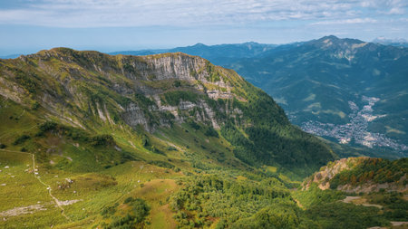 Alpine Meadows Trail, Krasnaya Polyana Resort. Alpine Meadows Walking Route. Aerial view of the green mountain valley, surrounded by high mountains.の写真素材