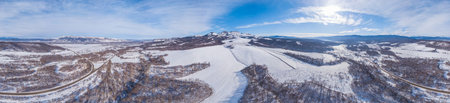 Great aerial mountain panoramic view of the snowy massive rock i