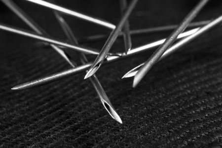 the needle of a medical syringe on a black background.の写真素材