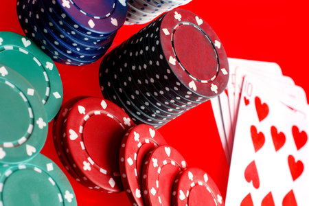 gambling chips and cards on a reflected surface,