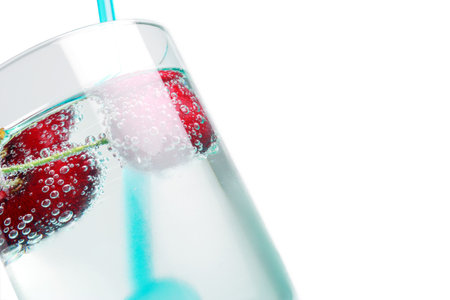 cherries in a drink with bubbles