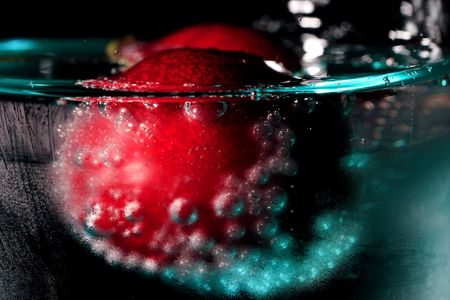 cherries in a drink with bubblesの写真素材