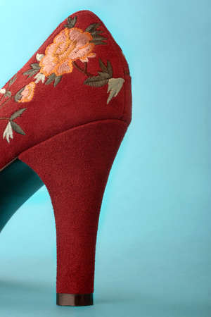 high heeled burgundy shoe with flower design, space at the side for textの写真素材