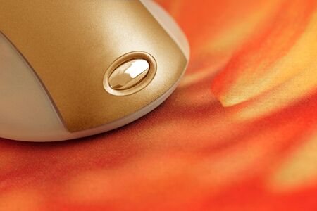 computer mouse on vibrant flame colored matの写真素材