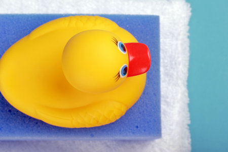 sponge, towel and rubber bath duckの写真素材