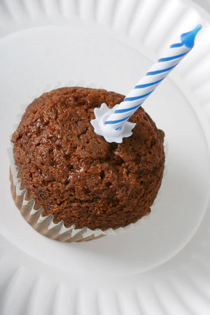 chocolate dessert, bun, muffin, fairy cake with a blue candleの写真素材