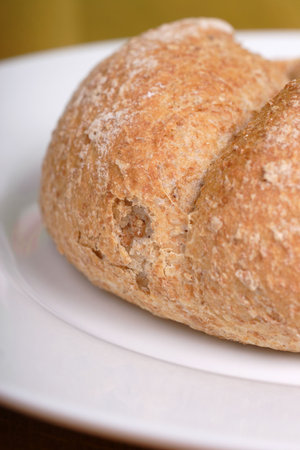 brown wholemeal breadcake on farmhouse wooden table