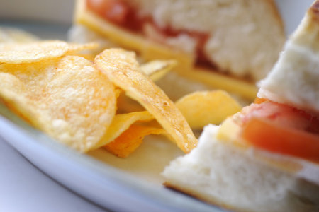 cheese and tomato sandwich with potato chips, shallow depth of fieldの写真素材