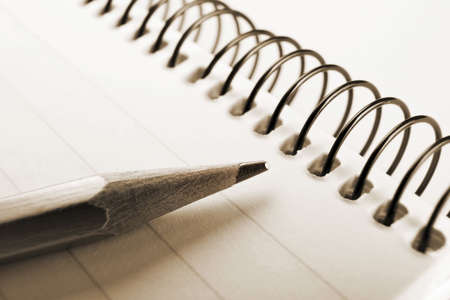 sepia note book and pencil.の写真素材