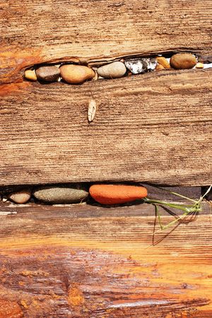 old worn beach groyne and pebblesの写真素材
