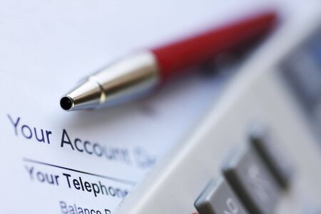 calculating and sorting bills for payment.の写真素材