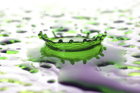 coloured water droplet splashing onto a surfaceの写真素材