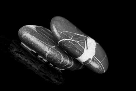 peace and tranquility,wet pebbles  reflected on black surfaceの写真素材