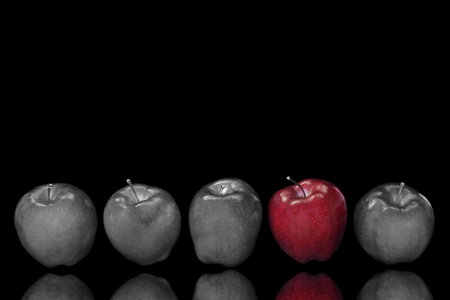 five apples in a row with selective colour appliedの写真素材