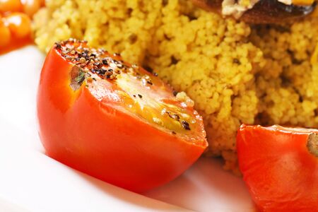 cooked tomatoes with black pepper seasoning with couscousの写真素材