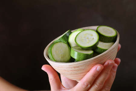 a bowl full of freshly prepared sliced courgettesの写真素材