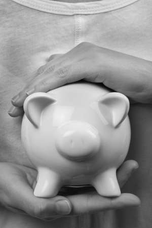 protecting your finances, secure hands around a money boxの写真素材