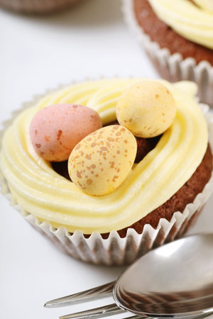 freshly baked Easter cupcakes with vanilla icing and chocolate eggs