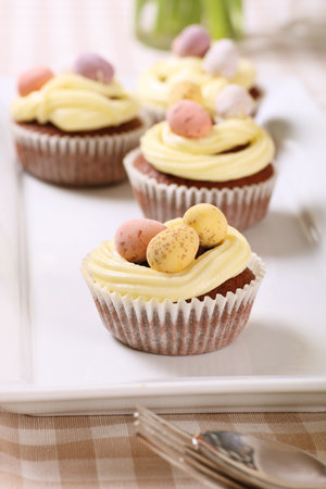 freshly baked Easter cupcakes with vanilla icing and chocolate eggs
