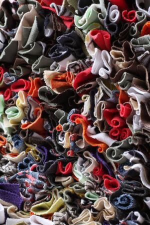 The front side of a traditional hand crafted rag rug i have created. It shows detail of textures and craft work. Made from old clothes cut into strips and prodded through a piece of hessian to form the rug.の写真素材