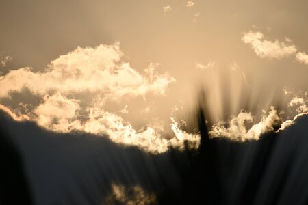 Sunset, sunrise with clouds, light rays and other dramatic effect.の写真素材