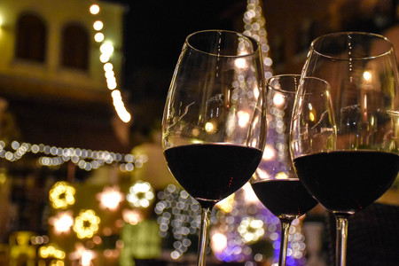 Glass of red wine at a nightly party.の写真素材