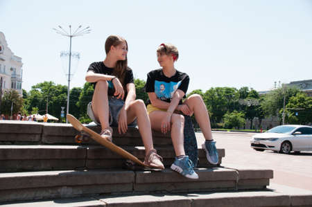 Ukraine, Chernihiv, June 28, 2020: charming woman with a skateboard in the center of a European city.のeditorial素材