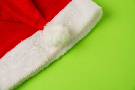 Santa claus hat on bright green background close up copy spaceの写真素材