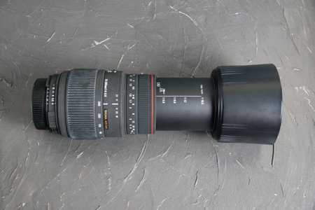 Ukraine, Chernihiv, February 21, 2023 : old Sigma lens with dust and scratches on a gray background.のeditorial素材