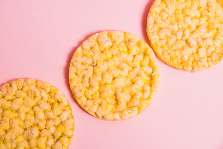 Flatlay, crispy, diet cornbread on a pink background.の写真素材