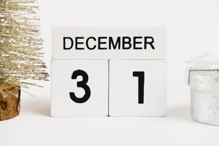 New Year, wooden calendar with the date December 31 and decor on a white background. The concept of preparing for the Christmas and New Year holidaysの写真素材