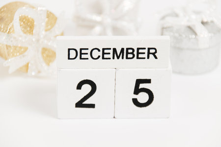 Christmas, wooden calendar with the date December 25 and decor on a white background. The concept of preparing for the Christmas and New Year holidaysの写真素材