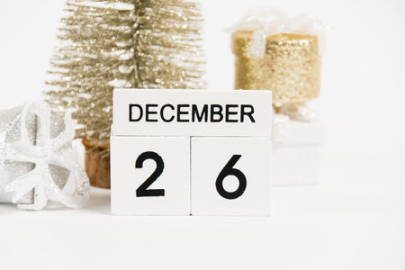 Boxing Day, wooden calendar with the date December 26 and decor on a white background. The concept...