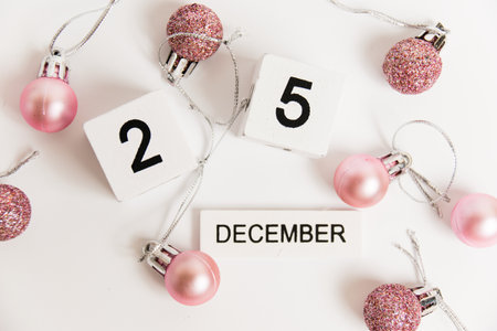 Christmas, wooden calendar with the date December 25 and decor on a white background. The concept of preparing for the Christmas and New Year holidaysの写真素材