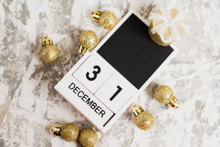 Flatlay, Christmas decoration and wooden calendar with date December 31 on light background, New Year. The concept of preparing for the celebration of Christmas and New Year and plans for the futureの写真素材